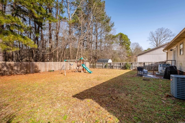 view of yard with central AC unit and a playground