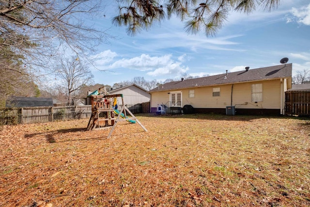 view of yard featuring cooling unit and a playground