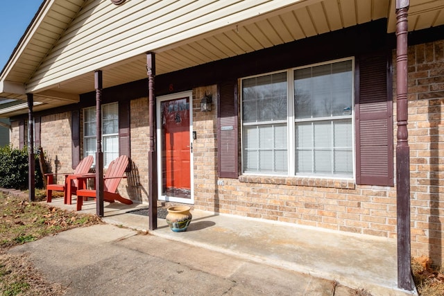 view of exterior entry with a porch