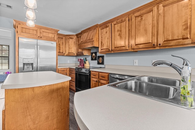 kitchen featuring visible vents, custom range hood, a sink, stainless steel appliances, and brown cabinetry