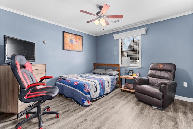 bedroom featuring visible vents, wood finished floors, crown molding, baseboards, and ceiling fan