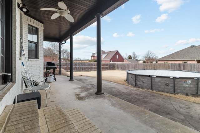 view of patio with a fenced backyard, a fenced in pool, a grill, and ceiling fan