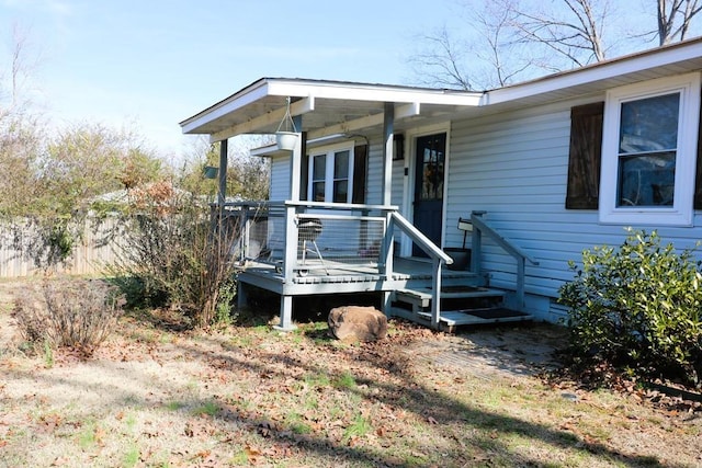 view of exterior entry with a deck