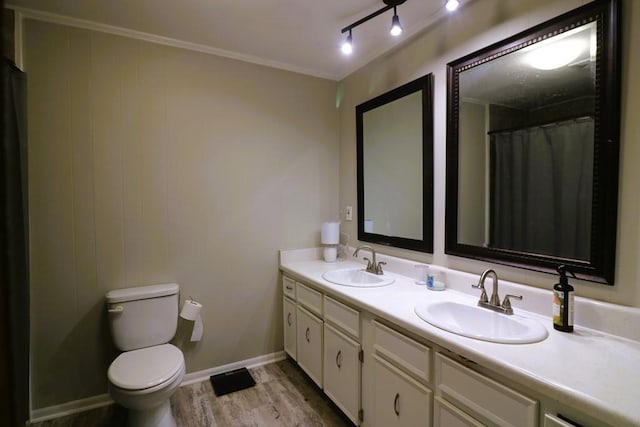 bathroom featuring hardwood / wood-style floors, vanity, ornamental molding, toilet, and walk in shower