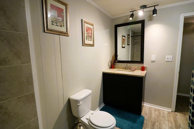 bathroom featuring ornamental molding, vanity, toilet, and hardwood / wood-style floors