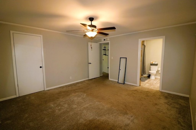 unfurnished bedroom with ceiling fan, ensuite bath, ornamental molding, and carpet