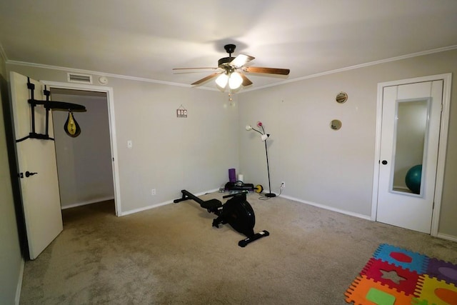 exercise room with ornamental molding, carpet flooring, and ceiling fan