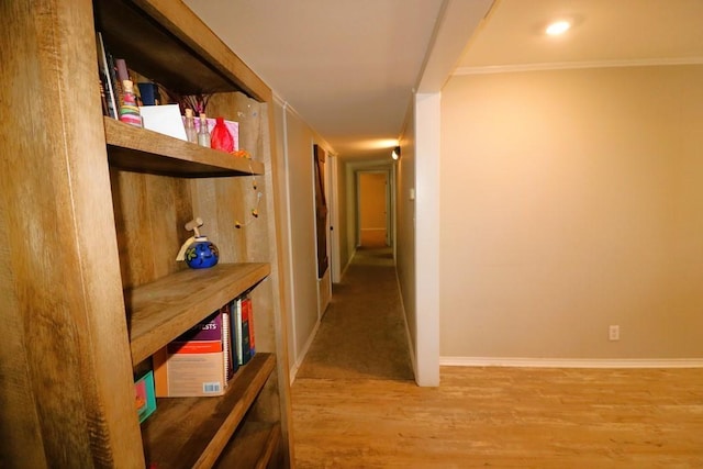 hallway featuring crown molding and hardwood / wood-style flooring