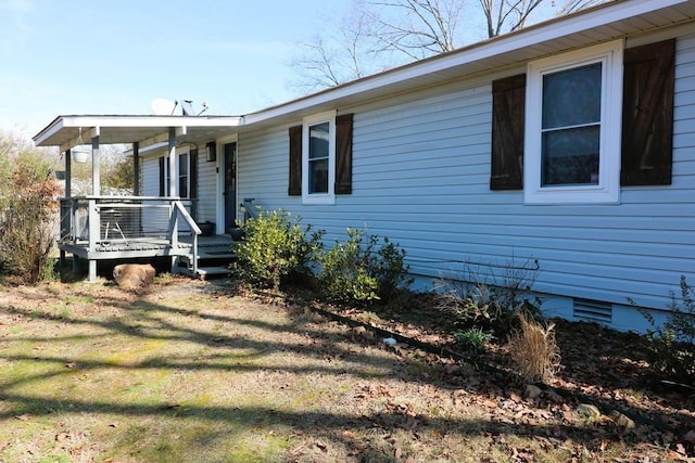 view of front of house with a deck and a front lawn