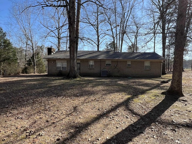 rear view of property with central AC