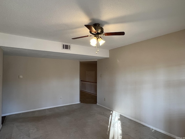 spare room featuring ceiling fan and a textured ceiling