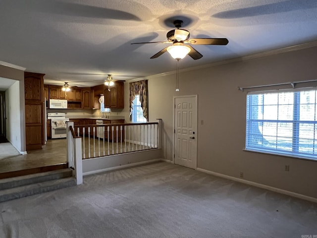 unfurnished living room featuring ornamental molding, carpet, and a wealth of natural light