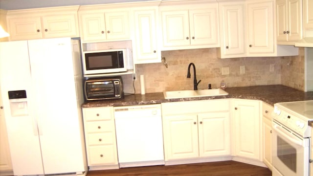 kitchen featuring dark hardwood / wood-style flooring, sink, white appliances, and backsplash