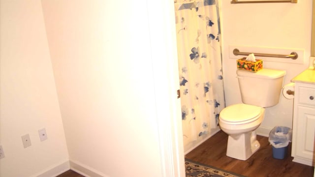 bathroom with vanity, hardwood / wood-style flooring, curtained shower, and toilet