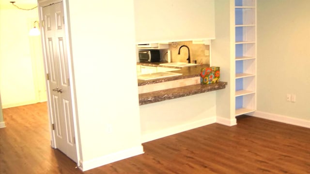 hall featuring sink and dark hardwood / wood-style floors