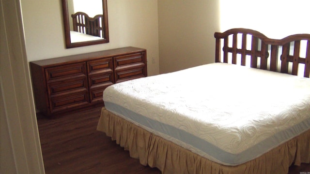 bedroom with dark wood-type flooring