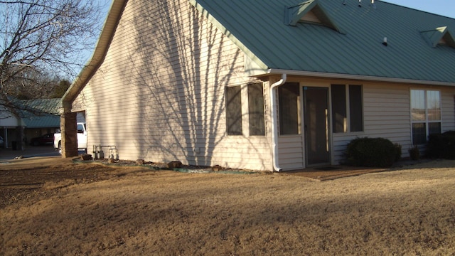 view of side of home featuring a lawn