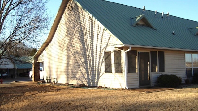 view of side of home with a yard