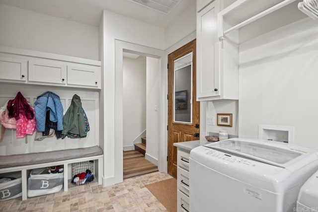 washroom featuring washing machine and dryer and cabinets