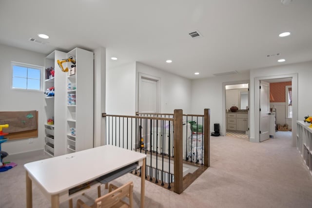 hall featuring light colored carpet