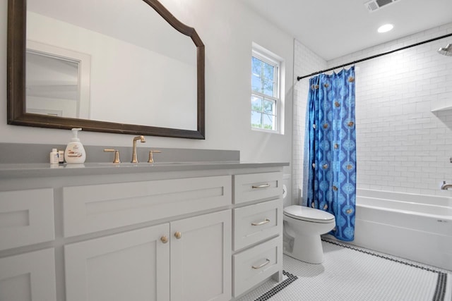 full bathroom featuring shower / bathtub combination with curtain, vanity, tile patterned floors, and toilet