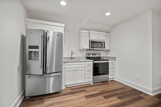 kitchen featuring white cabinetry, sink, dark wood-type flooring, and appliances with stainless steel finishes