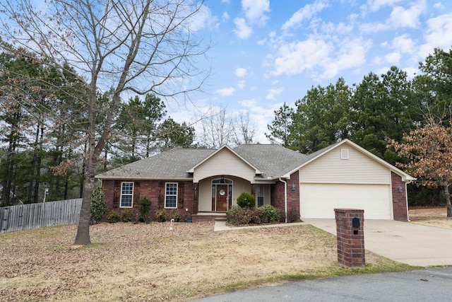 ranch-style home featuring a front lawn and a garage