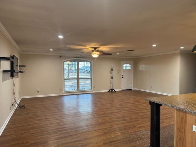 unfurnished living room featuring dark hardwood / wood-style flooring, crown molding, and ceiling fan