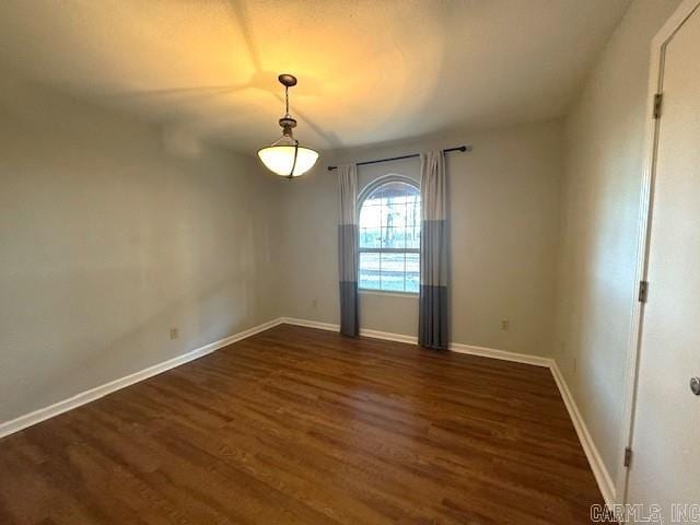 empty room with dark hardwood / wood-style floors