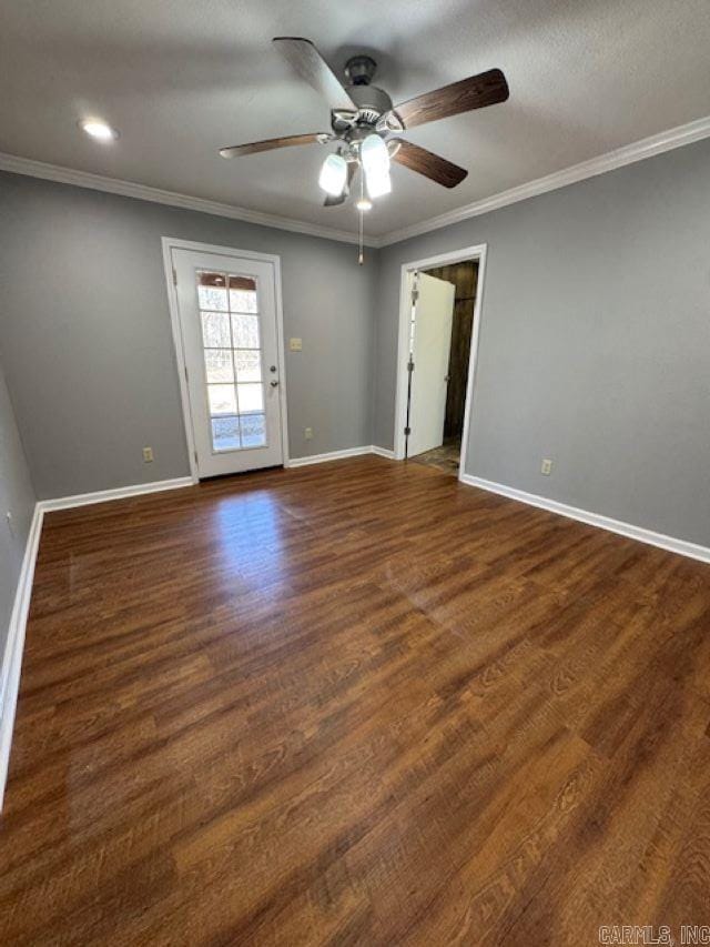 spare room featuring dark hardwood / wood-style flooring, a textured ceiling, ornamental molding, and ceiling fan