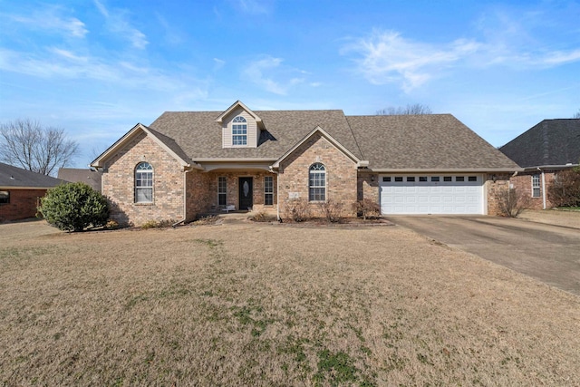 view of front of property featuring a garage and a front yard