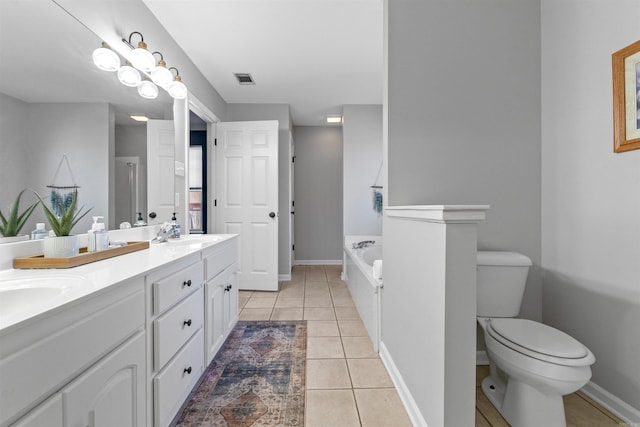 bathroom featuring toilet, tile patterned floors, a bath, and vanity