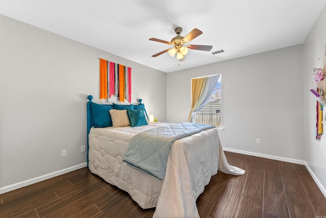 bedroom with dark hardwood / wood-style floors and ceiling fan