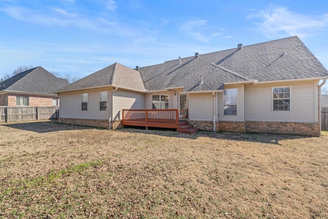 back of property with a wooden deck and a yard