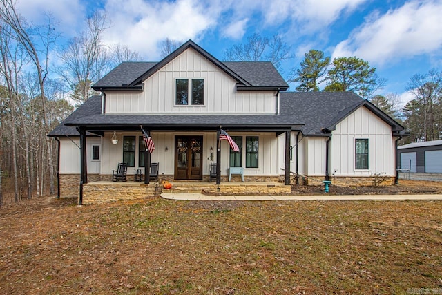 modern farmhouse with french doors, a patio area, covered porch, and a front lawn