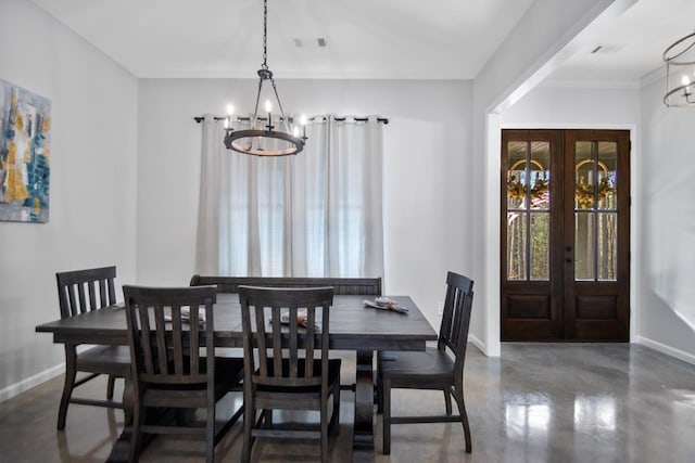 dining room featuring an inviting chandelier and french doors