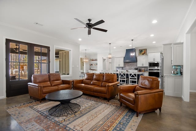 living room featuring ornamental molding, concrete floors, ceiling fan, and french doors