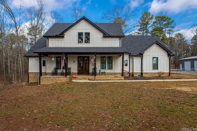 modern inspired farmhouse with a porch and a front yard