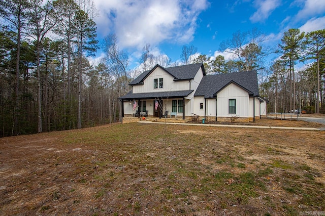 modern farmhouse featuring a front yard and a porch