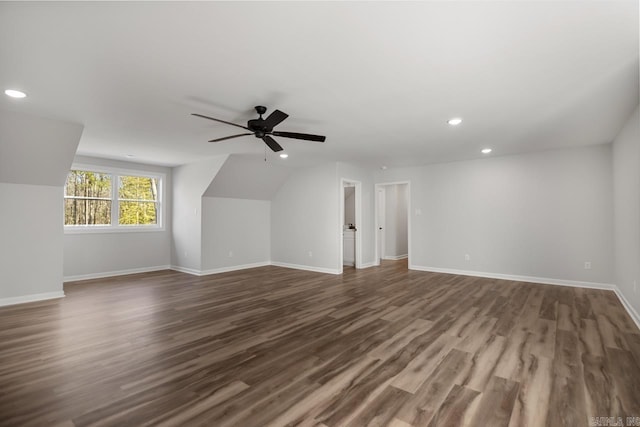 additional living space featuring dark wood-type flooring, ceiling fan, and lofted ceiling