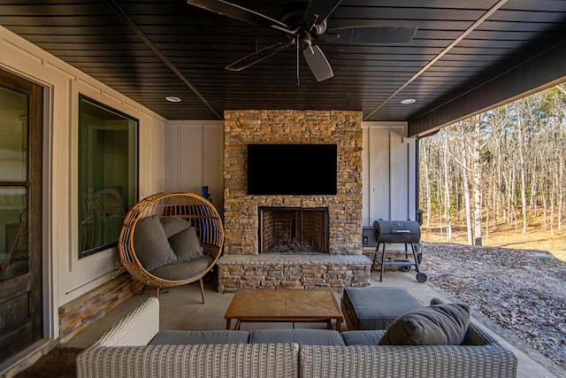 view of patio / terrace with ceiling fan, grilling area, and an outdoor stone fireplace