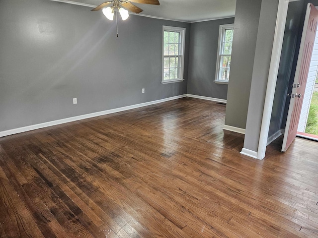 unfurnished room featuring dark wood-type flooring, ornamental molding, and ceiling fan