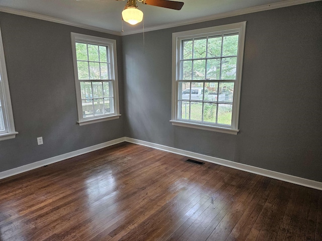 empty room featuring crown molding, ceiling fan, a healthy amount of sunlight, and dark hardwood / wood-style floors