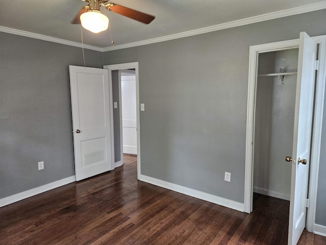 unfurnished bedroom featuring crown molding, dark hardwood / wood-style floors, ceiling fan, and a closet