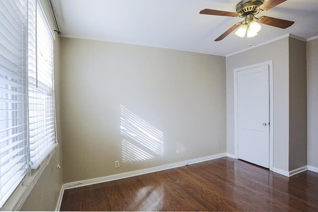 unfurnished room with crown molding, ceiling fan, and dark hardwood / wood-style flooring