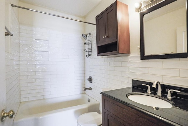 full bathroom with toilet, tasteful backsplash, tile walls, vanity, and tiled shower / bath combo