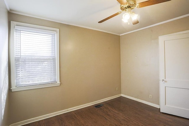 empty room featuring crown molding, dark wood-type flooring, and ceiling fan