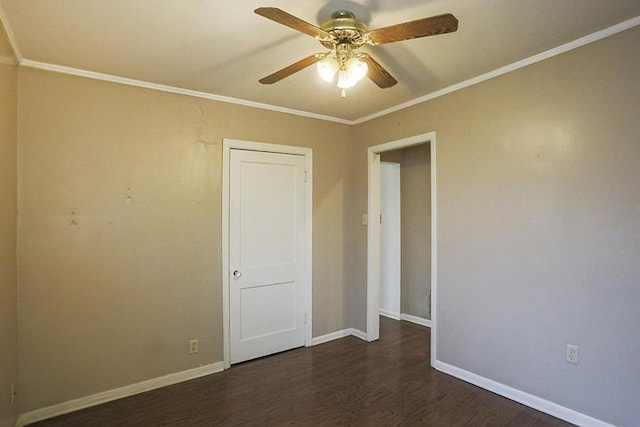 spare room with crown molding, ceiling fan, and dark hardwood / wood-style flooring