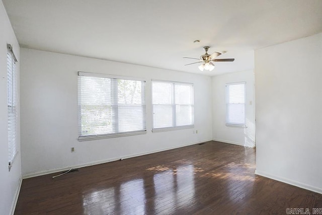 unfurnished room featuring dark wood-type flooring and ceiling fan