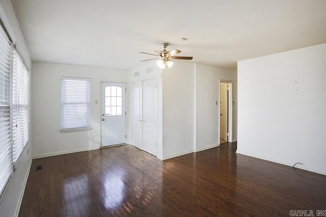 spare room featuring dark hardwood / wood-style flooring and ceiling fan